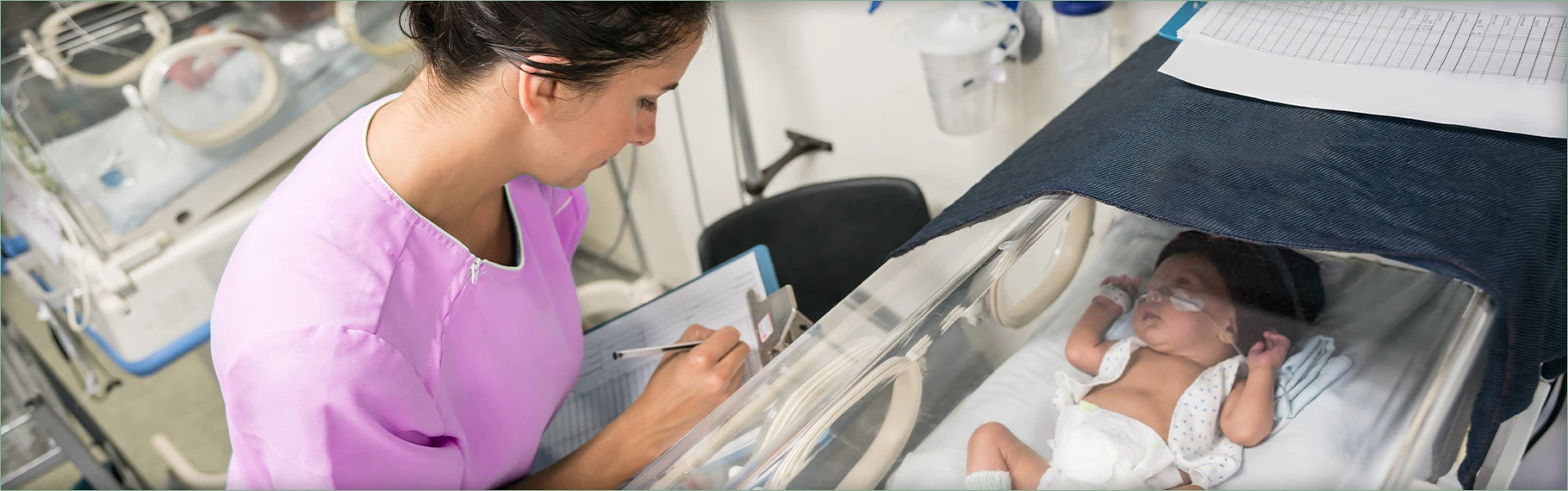 NICU nurse taking notes on rounds
